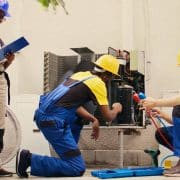 HVAC Mechanics cleaning condenser compressor